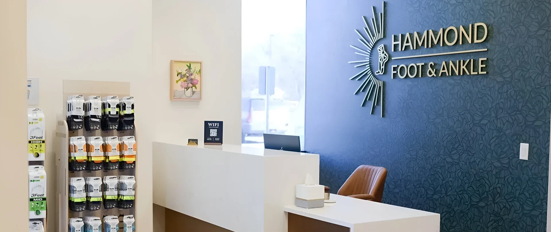 A white reception desk with a clock on the wall.
