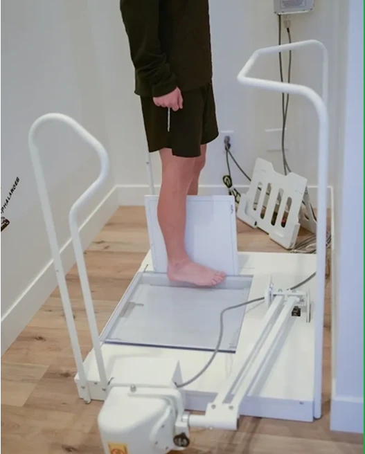 A person standing on a bed with a sheet over it