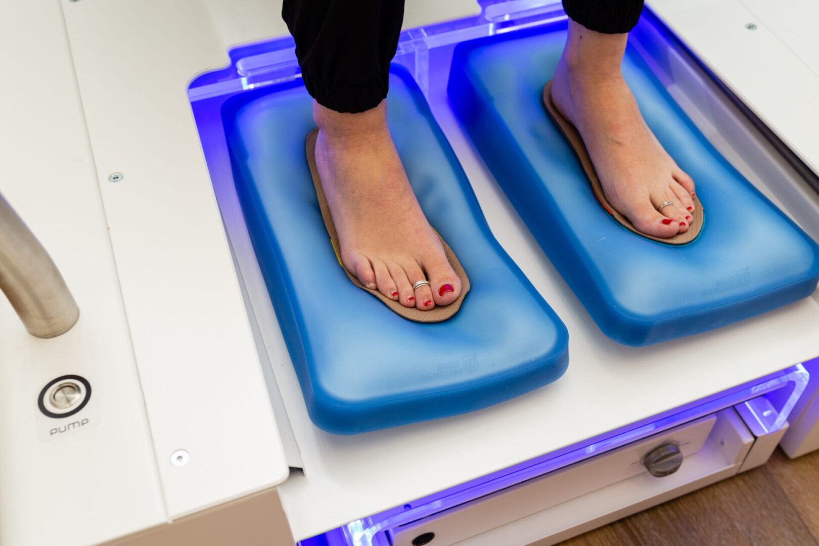 A person standing on a blue mat with their feet up.