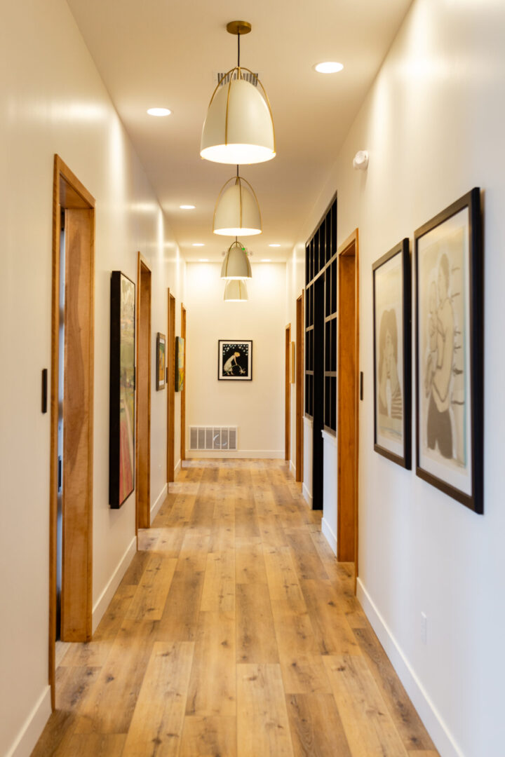 A hallway with many pictures on the wall.