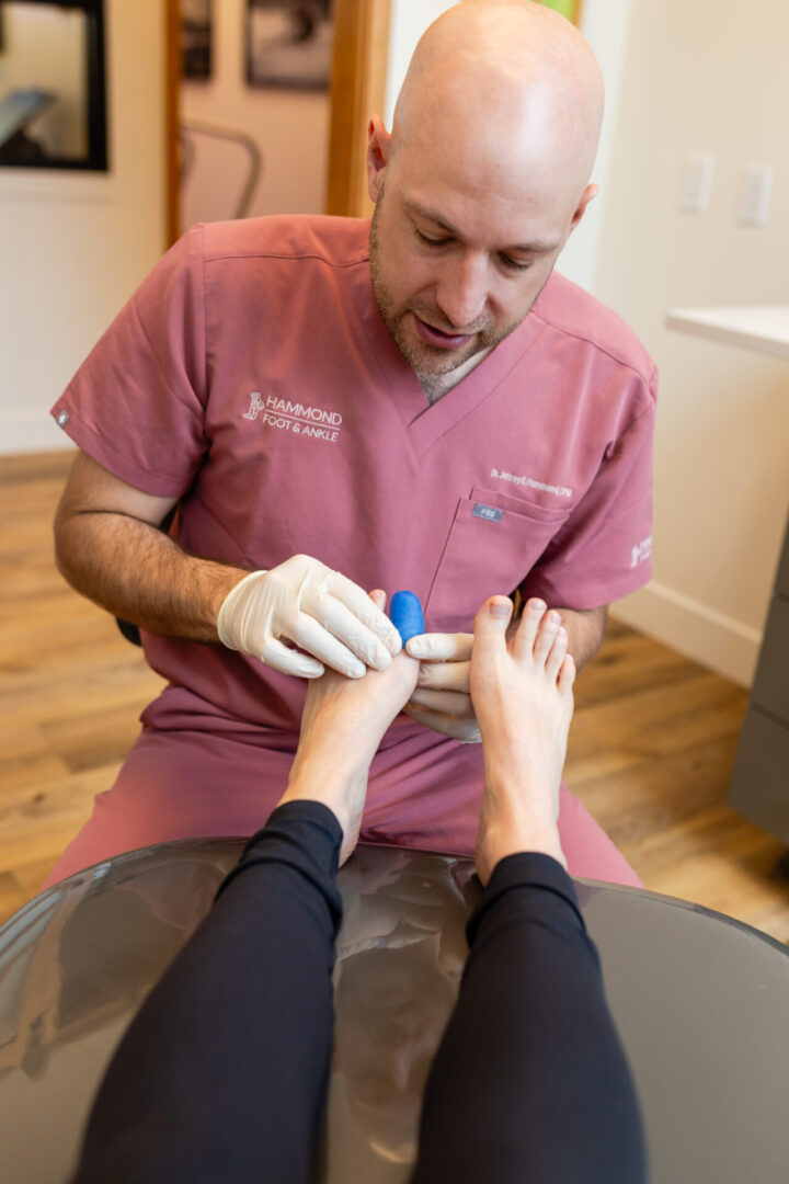 A doctor is giving a foot massage to a woman.