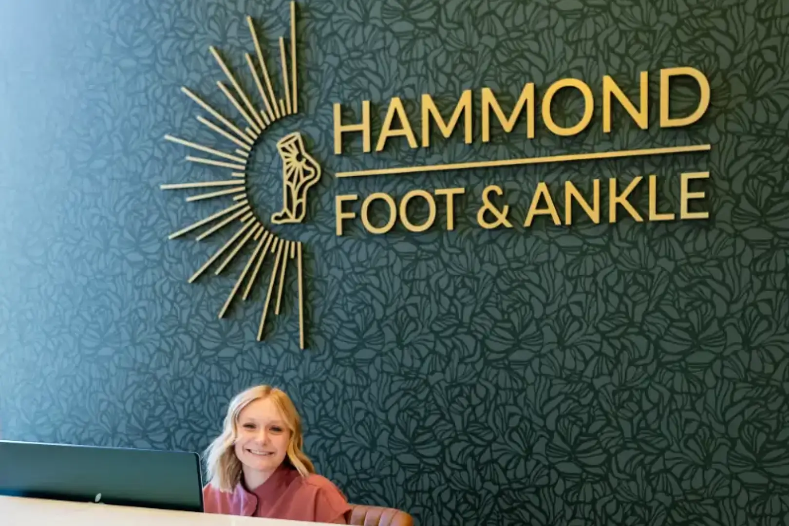 A woman sitting in front of hammon foot and ankle